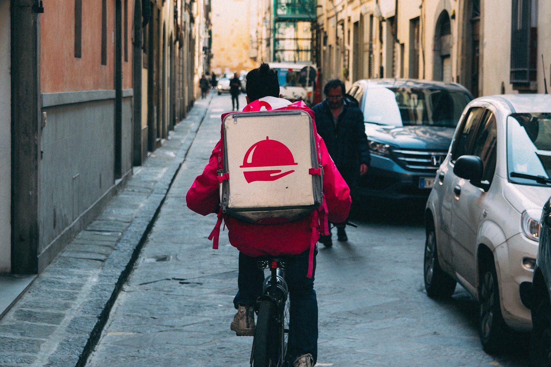 Man delivering food via a bike. Man delivering food via a bike.