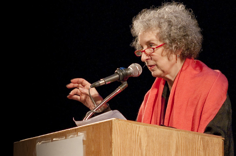 Margaret Atwood speaking at a stand. 