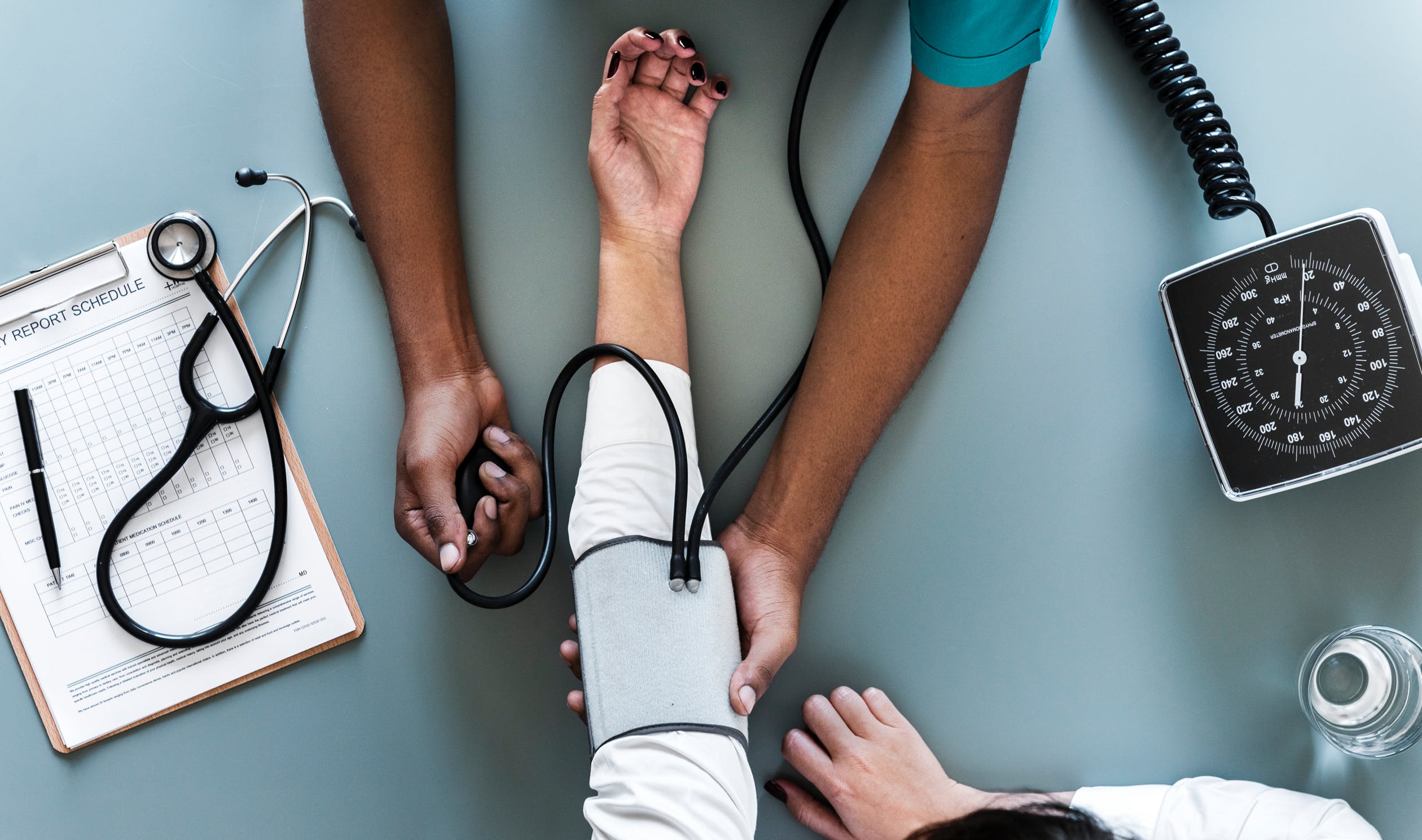 A doctor taking a patient's blood pressure