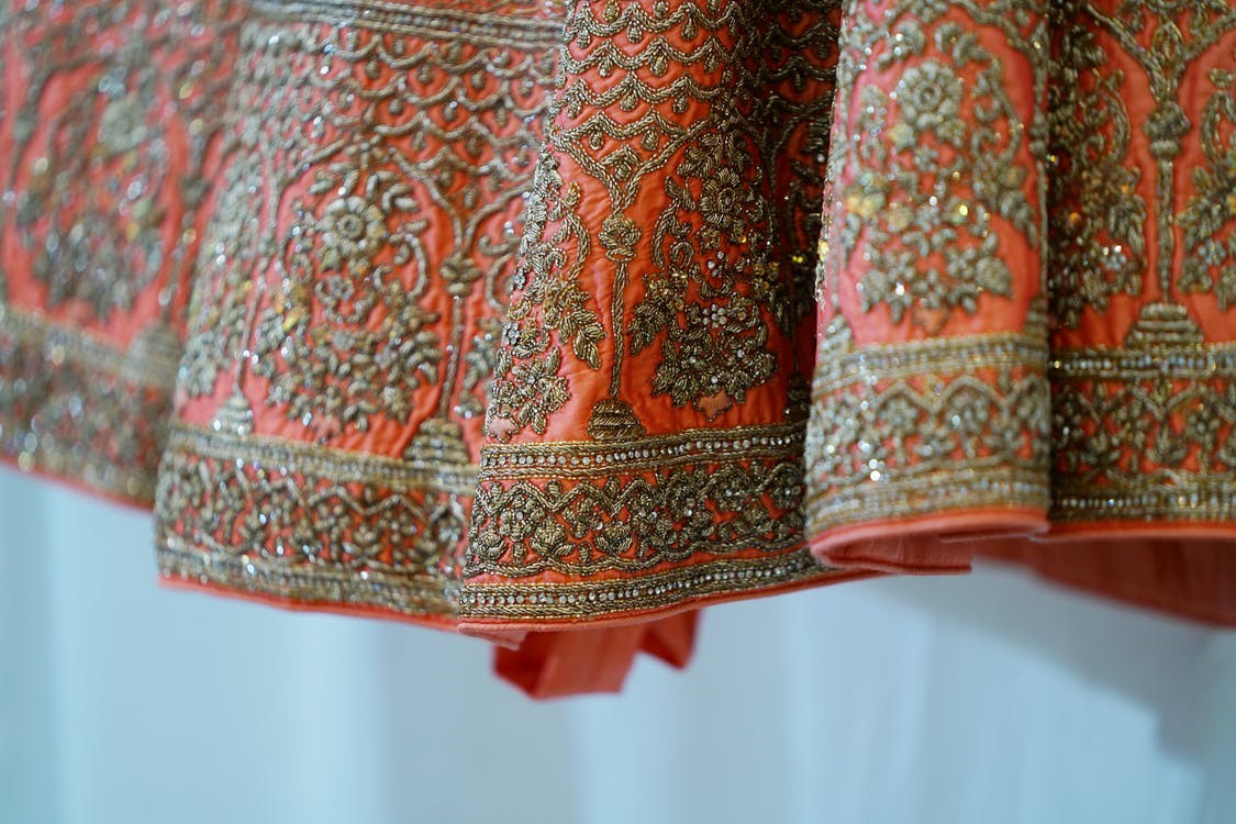 Red patterned sari material.