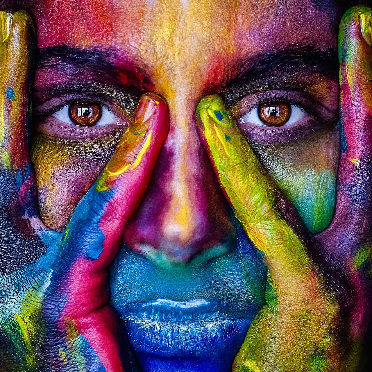 A close up of a person with colourful face paint