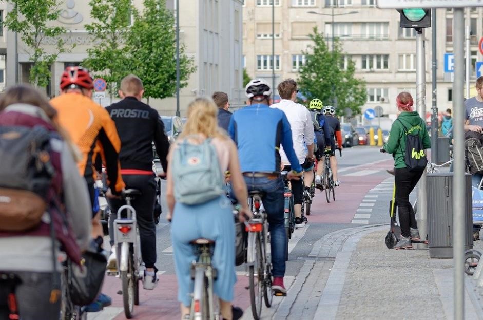 People cycling to work in a city setting.