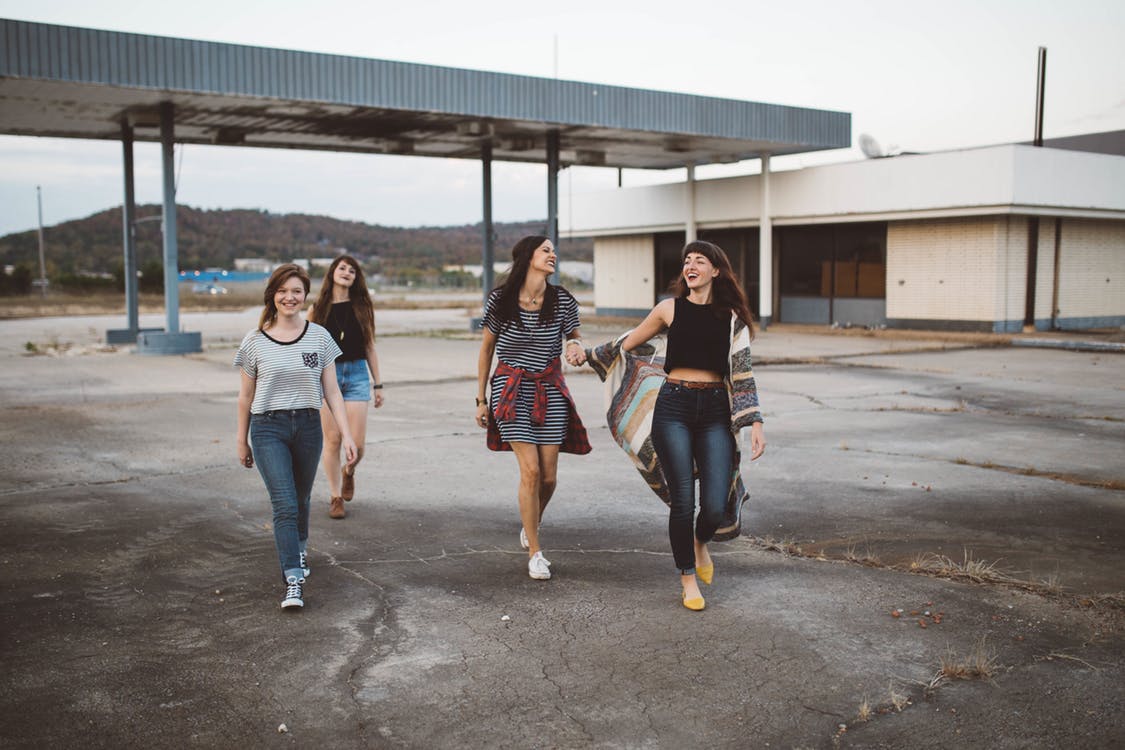 A group of friends walking and smiling 