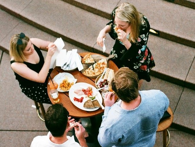 Four young people having a meal out 