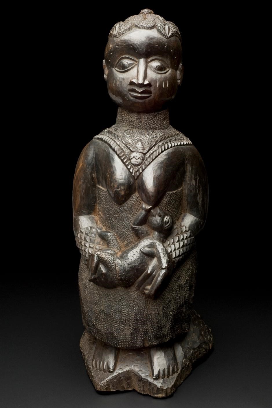 Carved figure of a woman breastfeeding, West Africa, 1890-1920