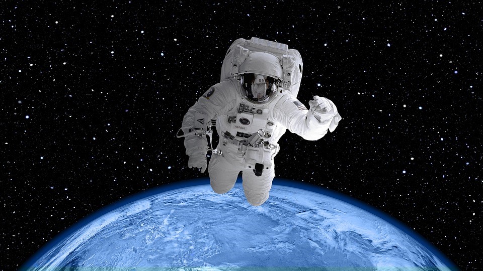 Astronaut with an aerial view of the Earth in the background