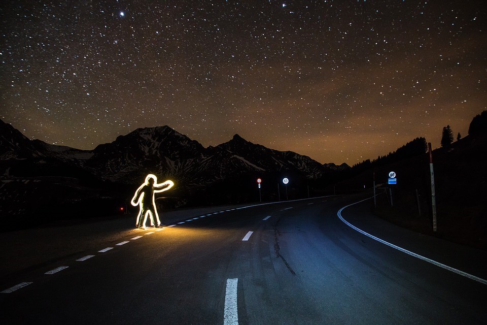Luminous man crossing the road at night