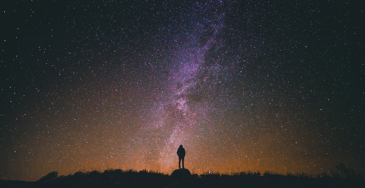 A person looking up at the night sky