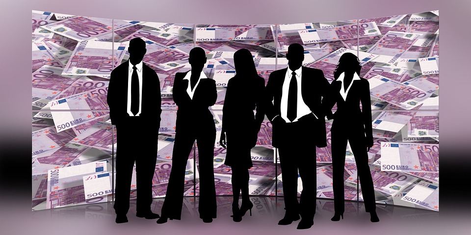 Five business people silhouettes in front of a backdrop of Euro notes.
